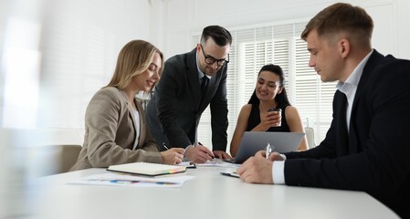 Marketing. Team of businesspeople working together at desk in office