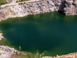 A large body of water surrounded by rocks and trees