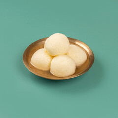 Traditional Indian Rasgulla Mithai in a Brass bowl Arranged Beautifully Together