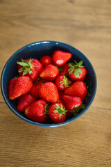 A beautifully vibrant bowl filled with fresh strawberries, showcasing their rich color, sweetness, and natural allure