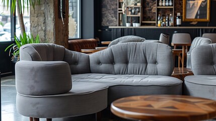Gray upholstered sectional sofa set in a modern cafe.
