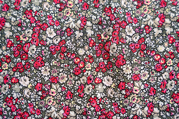 Red pink and white floral pattern on a green fabric texture background bg flowers