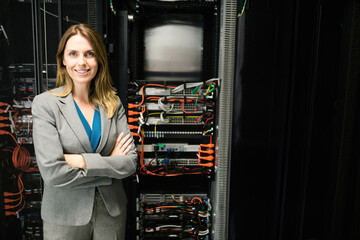 Woman standing in data center managing network switches and Ethernet cables, copy space