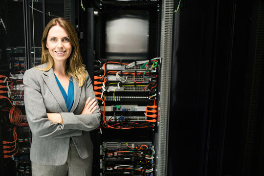 Woman standing in data center managing network switches and Ethernet cables, copy space