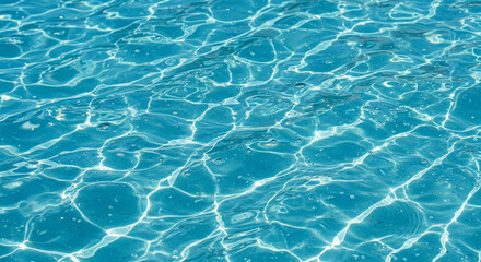Obraz premium Close-up view of sparkling blue water in a pool, showing light reflections