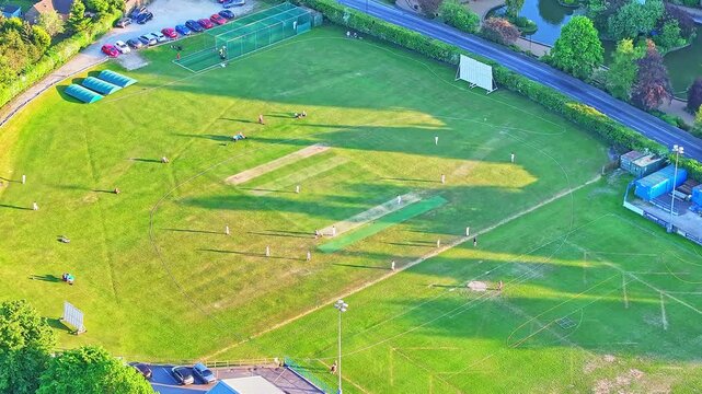 erial static shot of Matlock and Cromford Meadows Cricket Club shows a well-kept pitch bordered by the River Derwent, lush fields, and tree-lined meadows in the heart of Derbyshire&rsquo;s countryside.