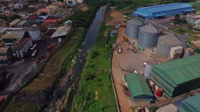 Aerial view of a polluted river running trough an industrial zone in Nigeria, Africa