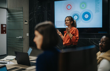 Business people strategizing in a modern office. They are focused on analyzing data and generating...