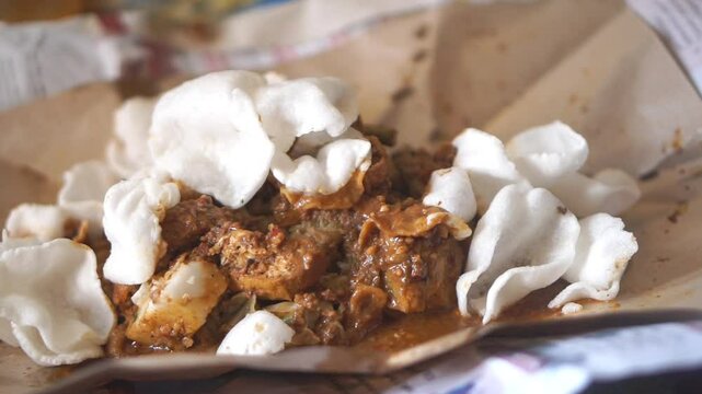 Kupat Tahu is a traditional Indonesian food made from ketupat, fried tofu, and vegetables such as cabbage and bean sprouts.