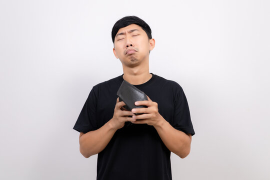 Asian man black shirt hold  no money wallet feel sad isolated