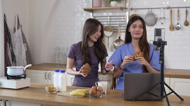 Woman nutritionist healthy food content creator live streaming with breakfast, milk, banana, bread and egg in kitchen, vlog, wellness, healthy cooking high protein food content for social media