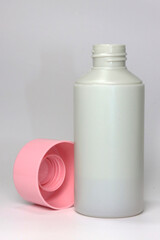 gray screw-top jar with pink lid on white background
