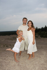 Cute family. Father, mother and daughter outdoors