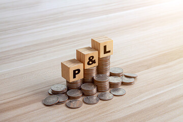 P L letters on wooden cubes and US dollar bills background. profit and loss concept
