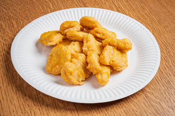 Tasty golden nuggets piled high on a plate invite delicious enjoyment during a cozy meal time