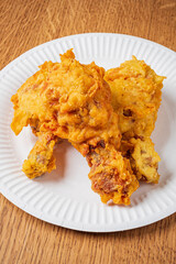 Juicy fried chicken drumsticks boast a perfect golden crust, inviting appetites at any gathering