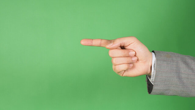 a hand in a gray suit and pointing with the index finger on  green screen background. - Powered by Adobe