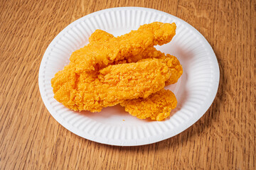 Delightful chicken tenders glisten with a crispy coating, inviting hunger at mealtime