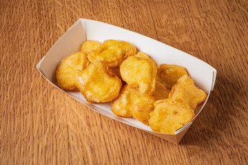 Delicious golden nuggets piled high in a paper tray, perfect for snacking or sharing