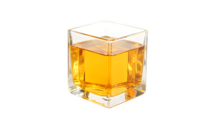 Another view of the amber liquid in a transparent cube on a white surface
