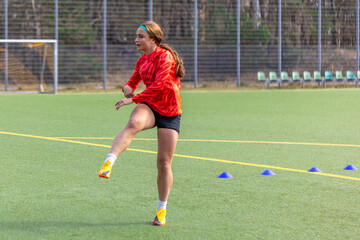 Girl soccer player. Girl in sports uniform on the soccer field. Football concept.