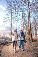 Fototapeta premium Two women walking in the forest. Forest. Nature. Outdoor recreation.