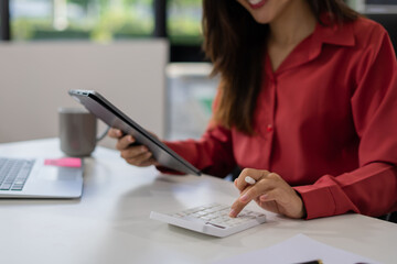 Business and financial concepts about office work. Analysts discuss business with a calculator as a tool.