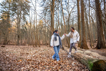 Fototapeta premium Two female friends on a walk in the forest. Friends walking through the forest. People in nature.
