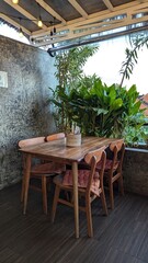 Fototapeta premium table and chairs in a garden cafe green vibes