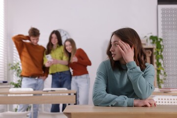 Teenage girl suffering from bullying at school, selective focus