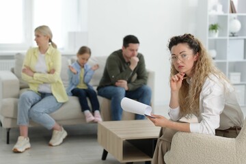 Obraz premium Family having consultation with psychologist in office, selective focus