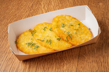 Delight in three crispy hash browns, perfectly golden and garnished with fragrant dill, served warm