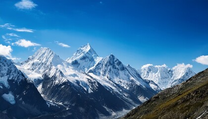 jagged snow capped peaks pierce a vibrant blue sky peaceful background