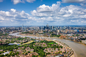 Panoramic summer day view of the London skyline with river Thames leading into the City, sunshine...