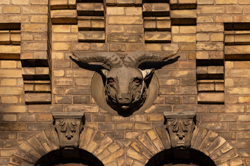 Stone Ram Head Decorates Historic Brick Building Facade in Vilnius, Lithuania
