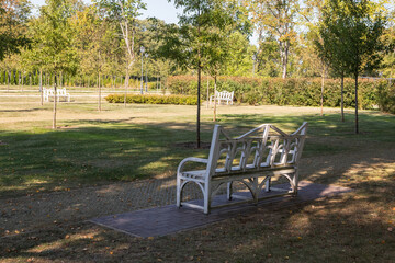White Benches Adorn Autumn Landscape of Traku Voke Park, Lithuania