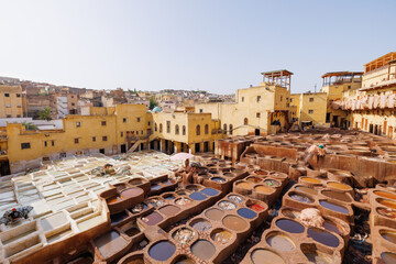Workers treat leather with softening liquids and dyes at Chouara Tannery, in the Medina quarter of...