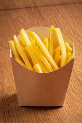 Crisp fries in a brown paper container, ready for tasty dips!