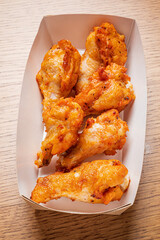 Crispy chicken wings neatly packed in a takeout box, great for casual dining or snacks