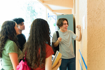 Excited high school student celebrating good grades with friends