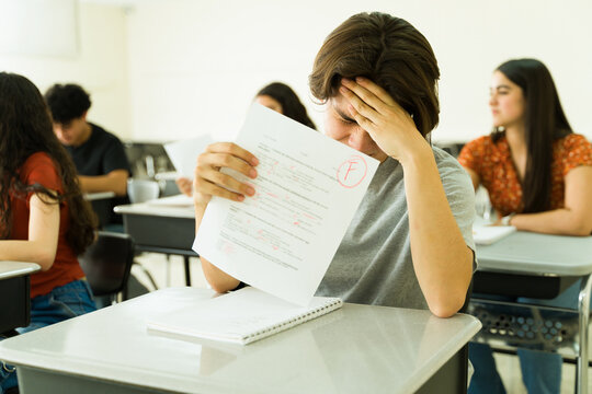 Sad latin student failing exam at high school