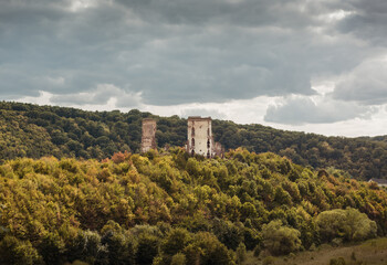 Chervonohorod Castle on a steep hill in the middle of the valley of the Dzhuryn river. Two tower ruins of abandoned castle near Nyrkiv, Ukraine.
