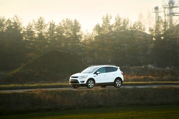 Luxury car driving on quiet country road