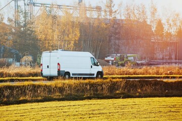 White transport van driving outdoor setting