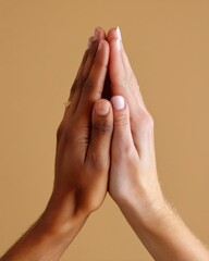 Two Hands Covered in Glitter Pressed Together Against a Beige Background