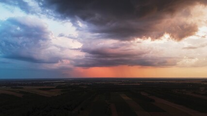 Summer evening sunset with vibrant sky and rain clouds