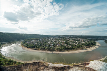 Small city located in the bend the Dniester River. Wide angle view of  the river bend in canyon....