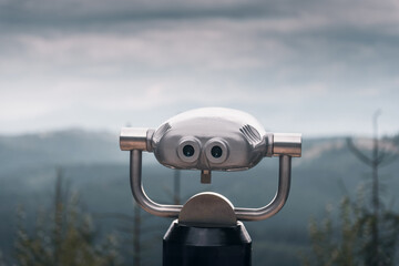 Coin operated binoculars on top of the mountain. Metal binoculars overlooking Carpathian mountains...