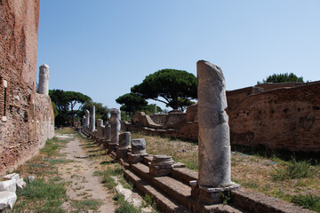 Ancient Roman ruins with brick structures and arches under a clear blue sky