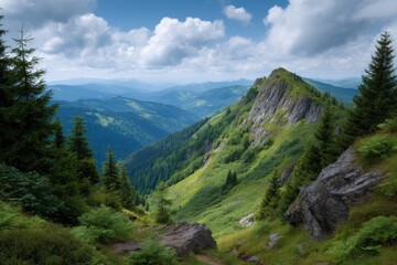 Obraz premium Mountain landscape with a rocky peak green slopes and distant blue hills under a cloudy sky